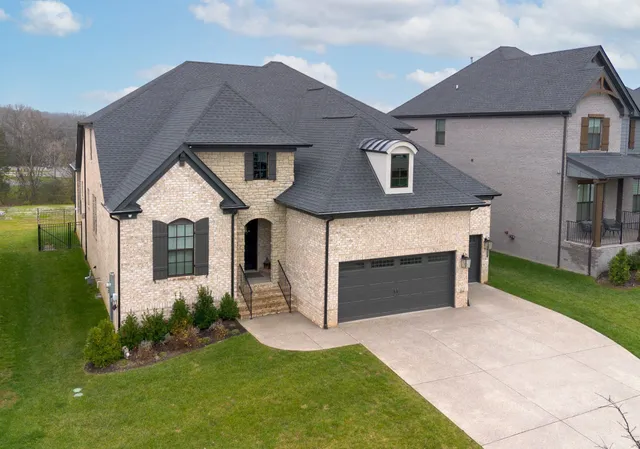 a front view of a house with a yard and garage