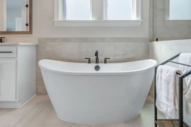 a bedroom with a bed a dresser and a window