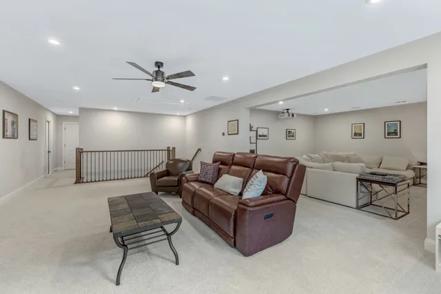 a living room with furniture a floor to ceiling window and a flat screen tv