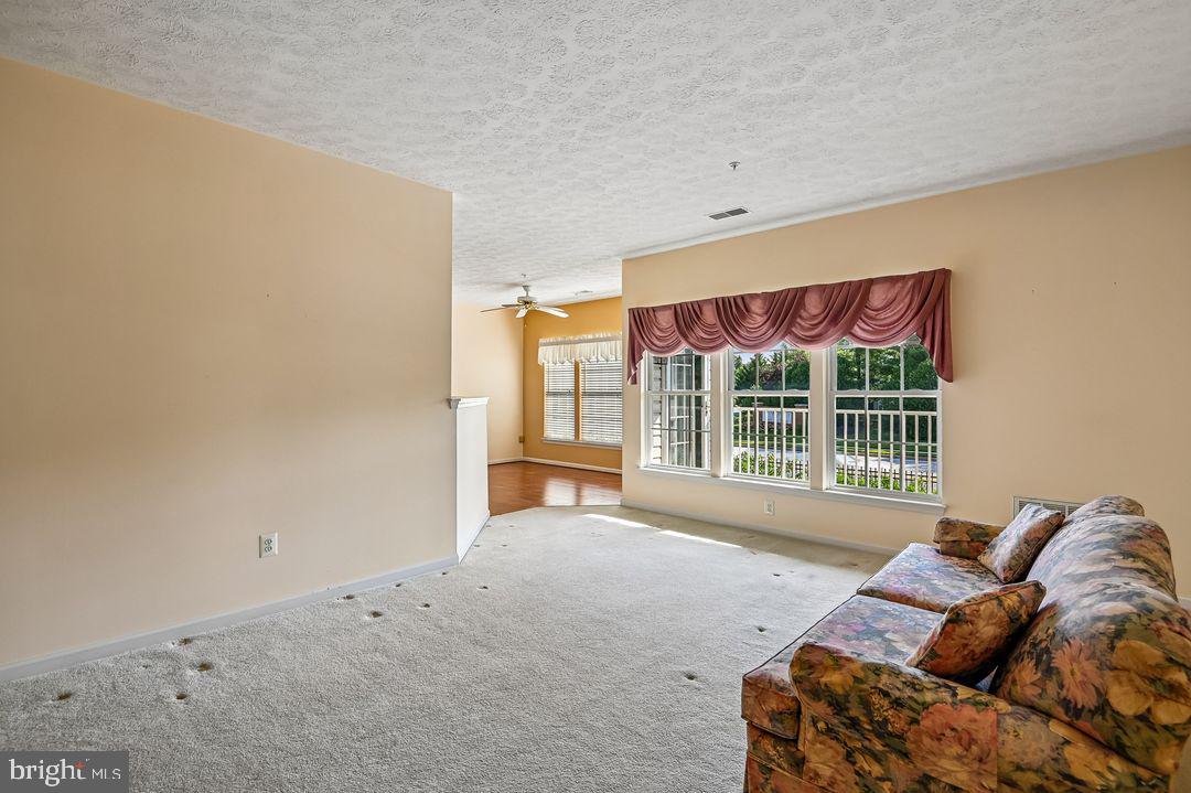 9511 Kingscroft Terrace, Unit 9511F Perry Hall, MD 21128 - Photo 14 of 38 a living room with furniture and a window