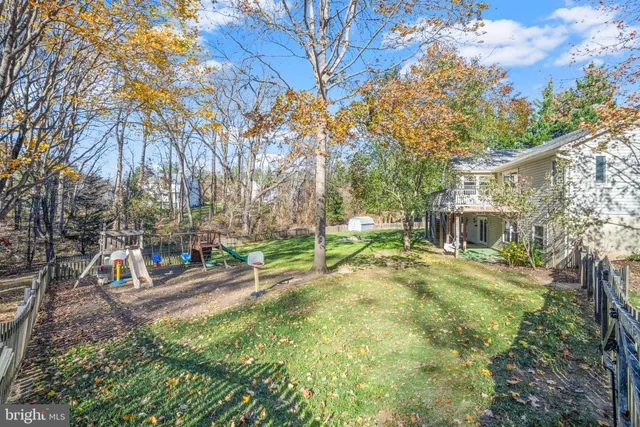 a view of a backyard with table and chairs under an umbrella