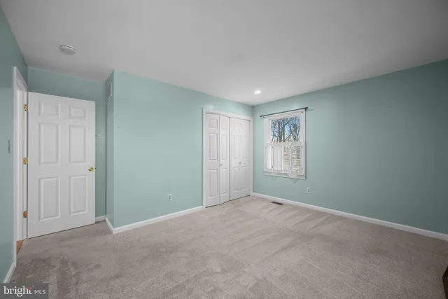 a view of an empty room with windows