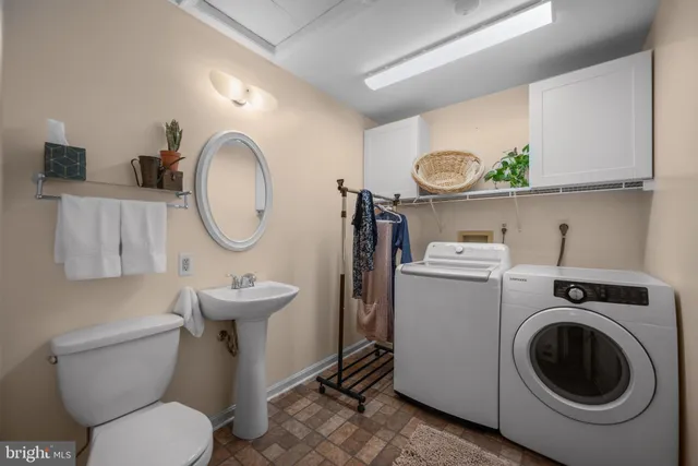 a bathroom with a toilet a sink and a mirror