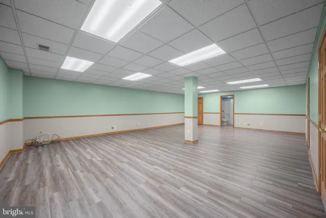 a view of a room with wooden floors