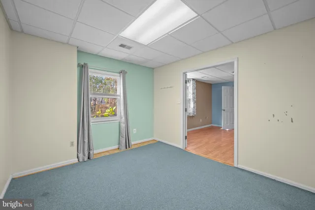 an empty room with closet and windows