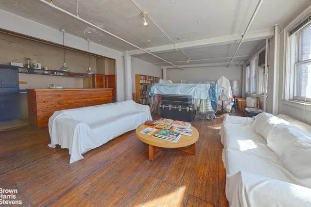 a large kitchen with stainless steel appliances granite countertop a lot of counter space and wooden floor