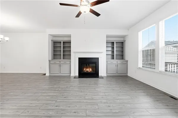 a view of a livingroom with a fireplace and window