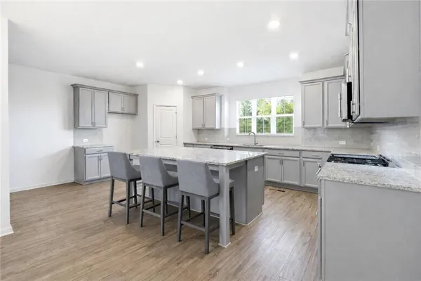 a kitchen with granite countertop a sink cabinets and window