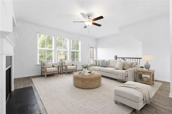 a living room with furniture and a large window with garden view