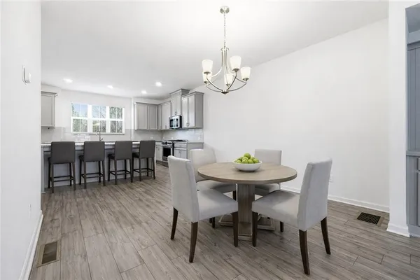 a view of a dining room with furniture and wooden floor