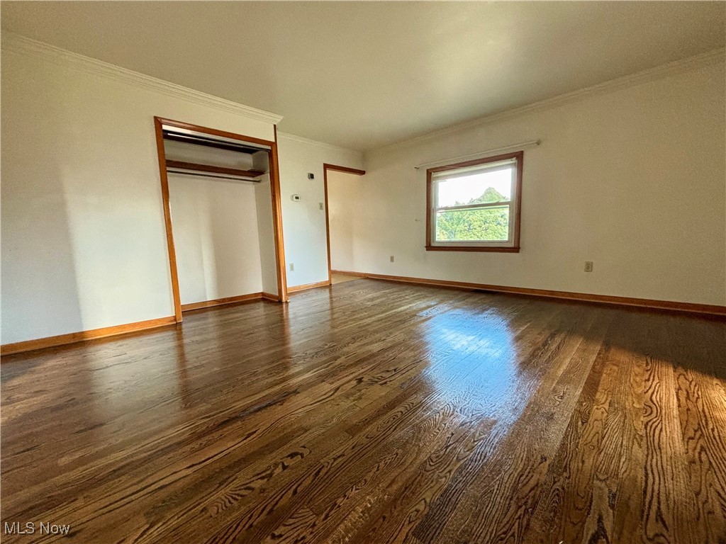 164 Locust Lane Follansbee, WV 26037 - Photo 5 of 19 Unfurnished bedroom with crown molding, dark wood-type flooring, and a closet
