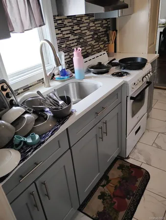 a kitchen with a stove and a sink