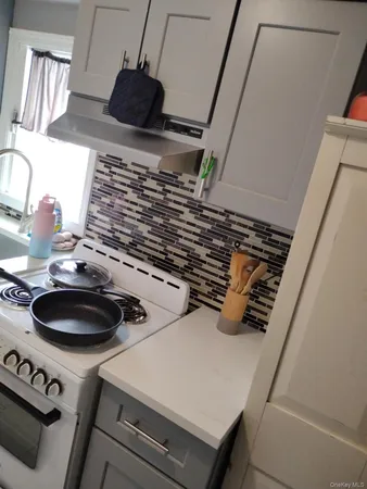 a kitchen with a sink a stove and a microwave