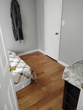 a bedroom with a bed and painting on the wall