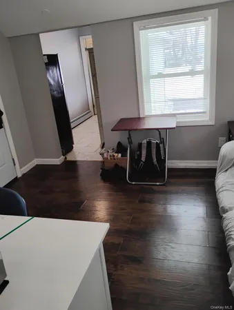 a view of a living room with furniture and wooden floor