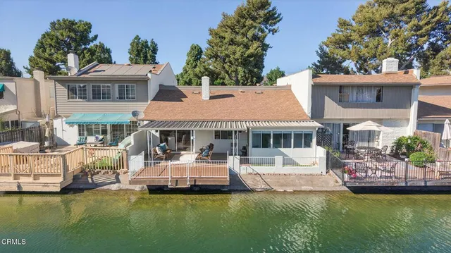 a front view of a house with a garden and swimming pool