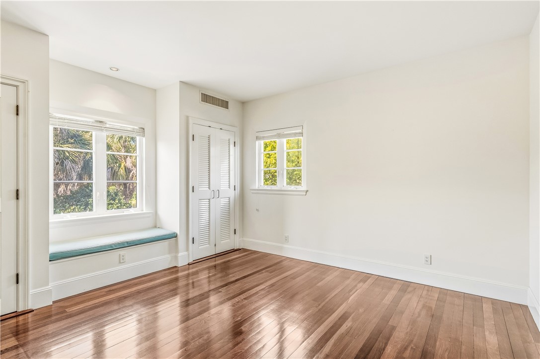 2350 Quay Dock Road Vero Beach, FL 32967 - Photo 23 of 35 an empty room with wooden floor and windows