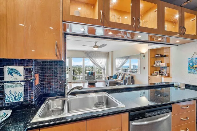 a view of a kitchen counter top a sink and a window
