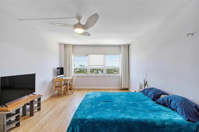 a bedroom with a bed and a table