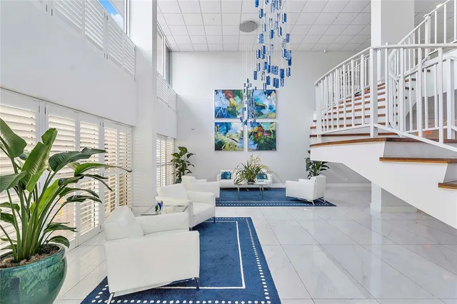 a living room with furniture and a chandelier