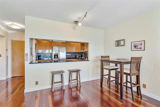 a room with a table chairs and wooden floor