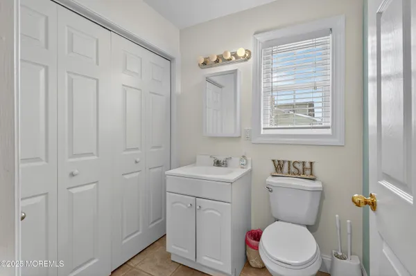 a white toilet sitting next to a bathroom sink