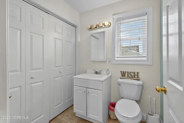 a white toilet sitting next to a bathroom sink