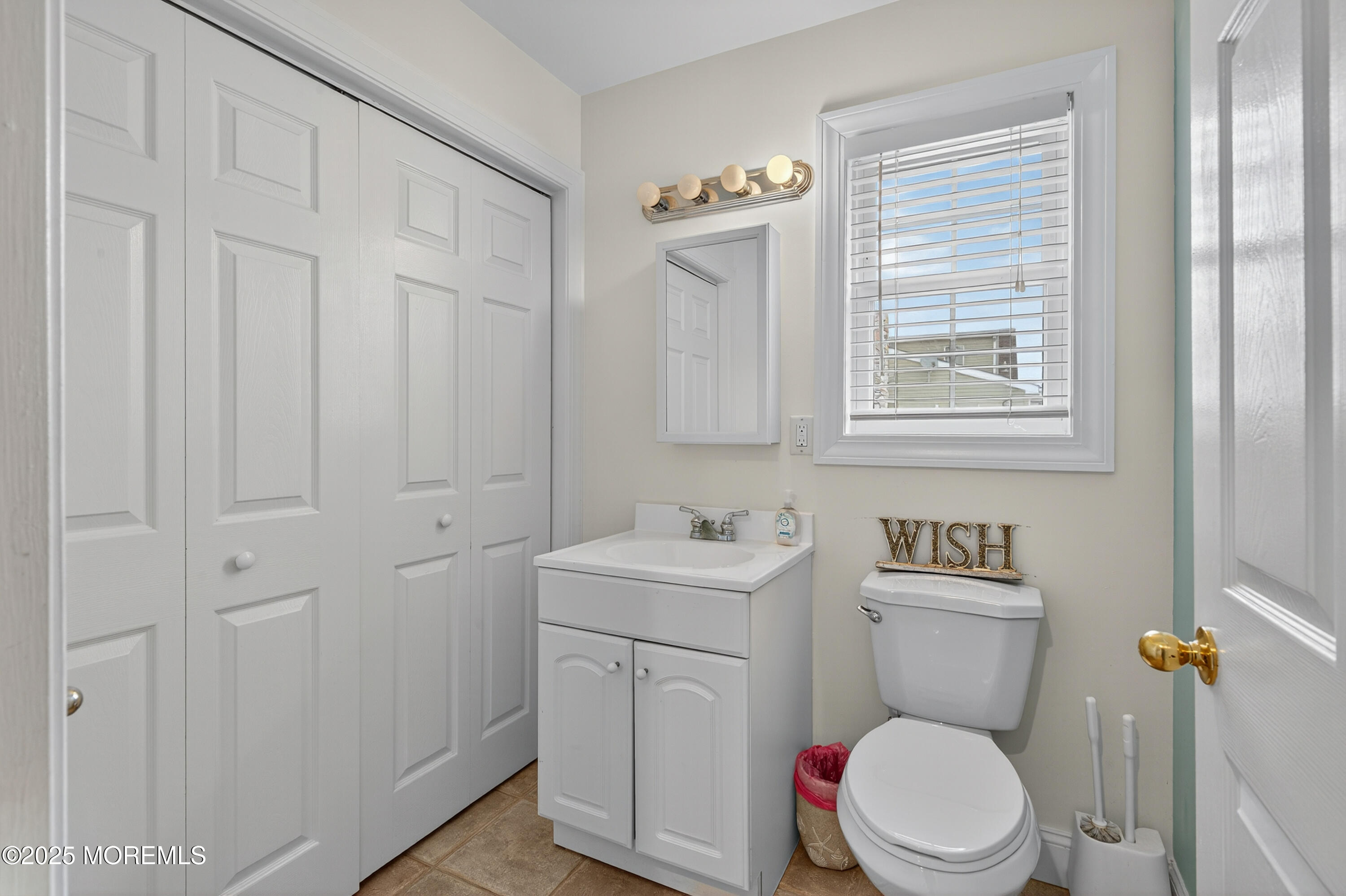 A19 Haddonfield Avenue Lavallette, NJ 08735 - Photo 19 of 24 a white toilet sitting next to a bathroom sink