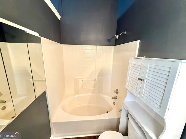 a bathroom with a bathtub and a shower