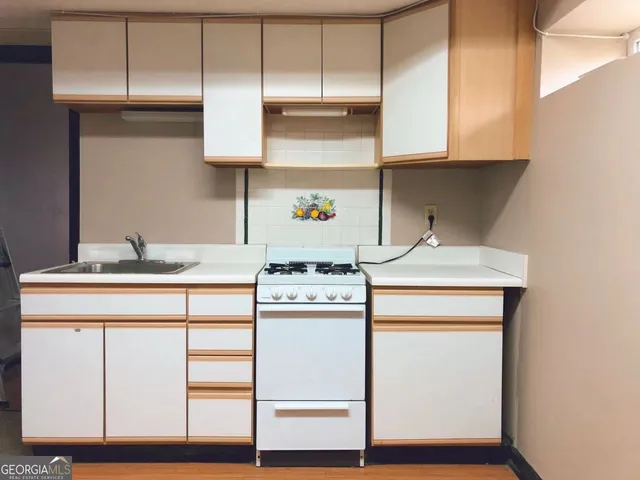 a kitchen with kitchen island granite countertop wooden cabinets and white appliances