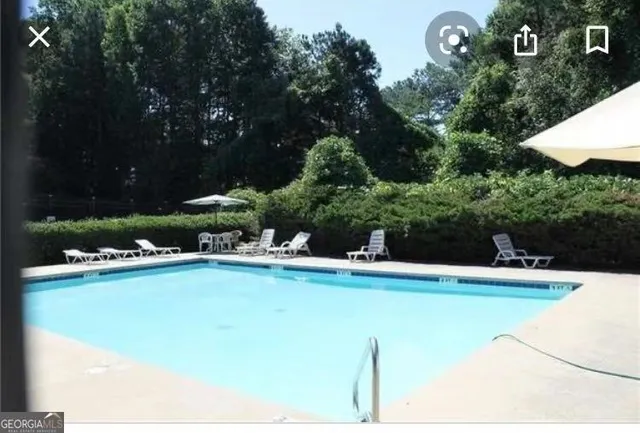 a view of a swimming pool and lounge chair