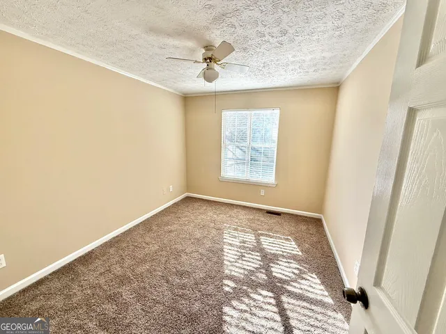 an empty room with windows and closet