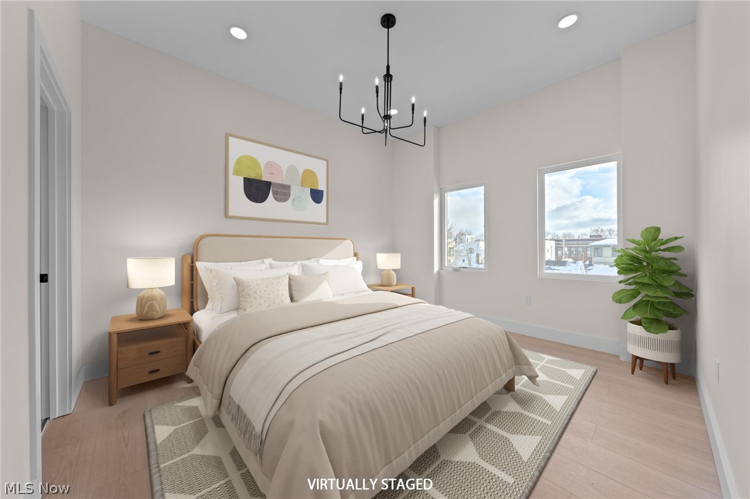 2149 Columbus Road Cleveland, OH 44113 - Photo 16 of 38 Bedroom with light wood-style floors and suspended lighting