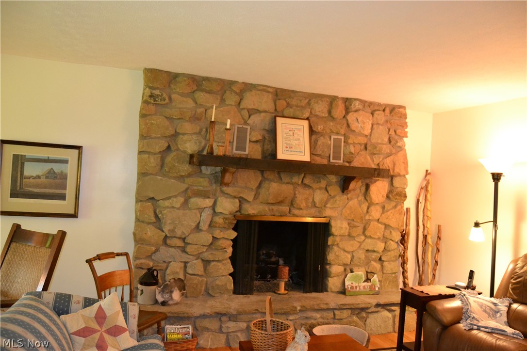 742 Highland Ridge Road Lowell, OH 45744 - Photo 15 of 31 The living room is quite large and one half is a cozy seating area by the gas log stone fireplace.