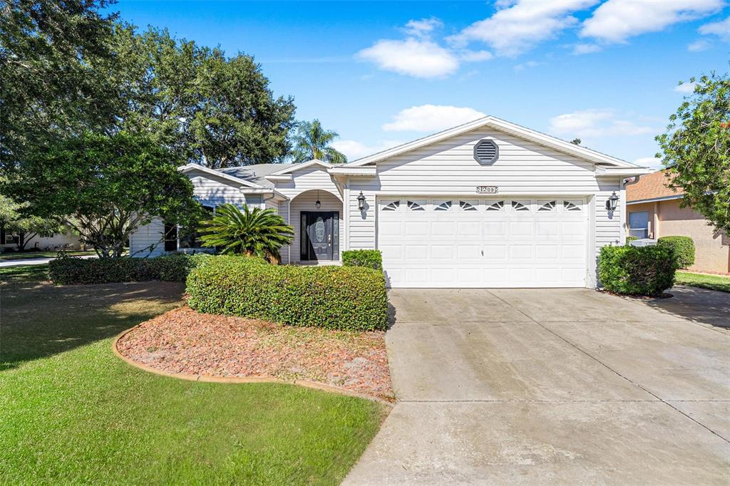 a front view of a house with a yard and garage