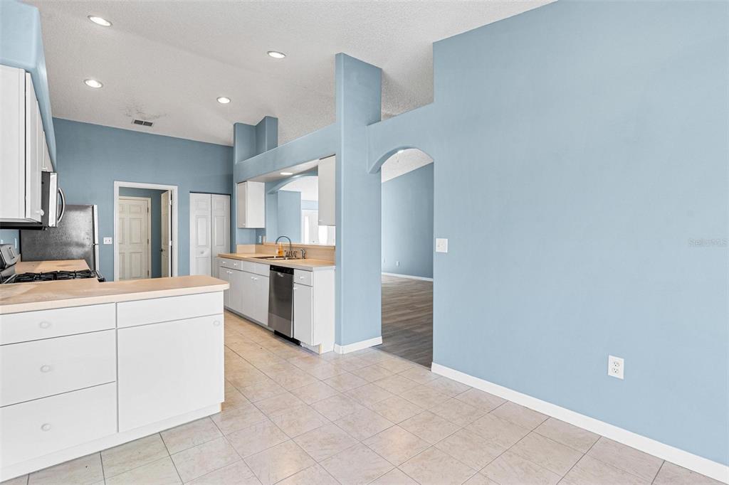 1009 Forest Breeze Path Leesburg, FL 34748 - Photo 12 of 28 a large white kitchen with cabinets