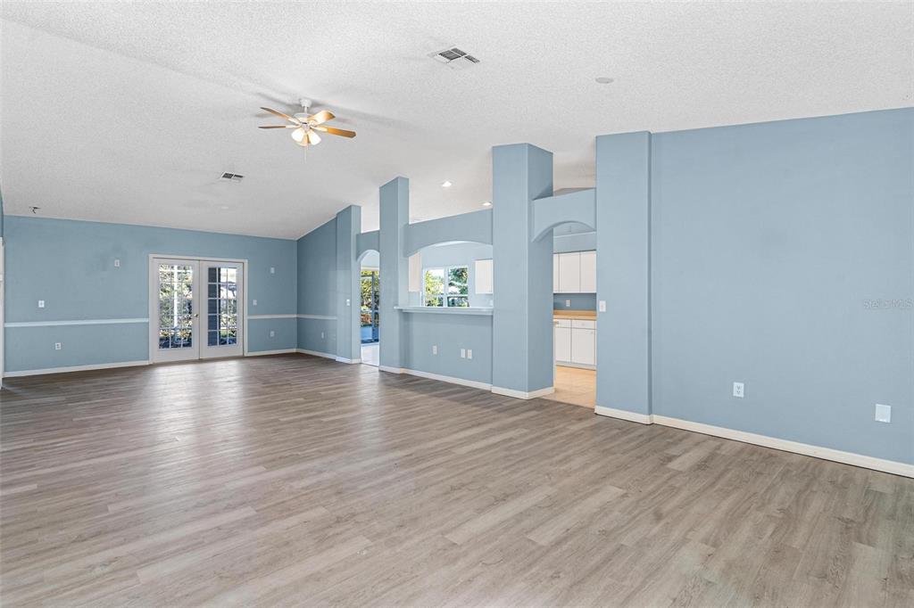 1009 Forest Breeze Path Leesburg, FL 34748 - Photo 4 of 28 a view of an empty room with window and wooden floor