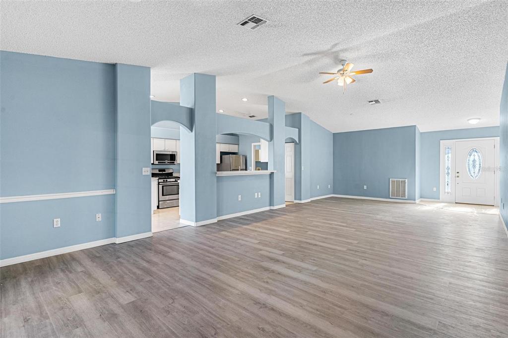 1009 Forest Breeze Path Leesburg, FL 34748 - Photo 6 of 28 a view of a kitchen with a sink and a refrigerator