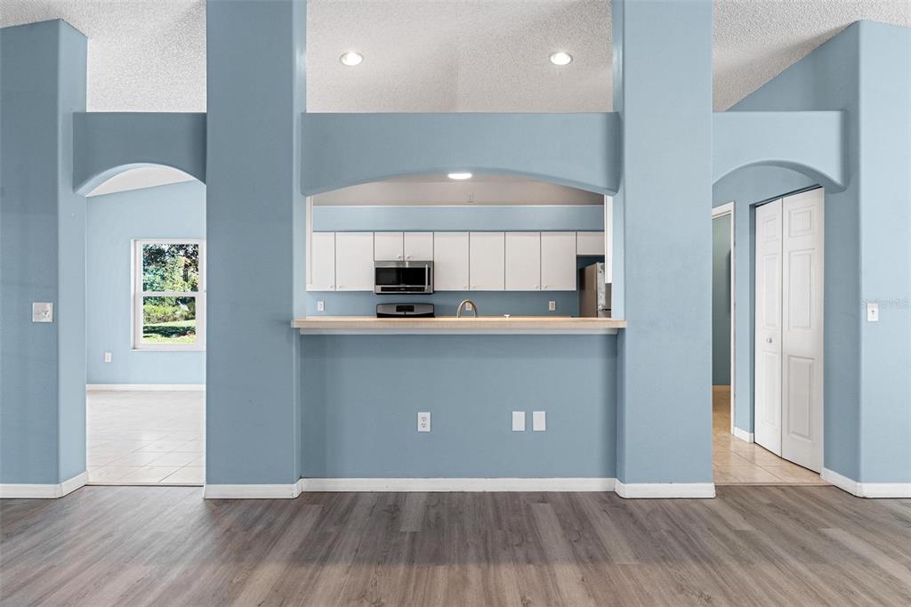 1009 Forest Breeze Path Leesburg, FL 34748 - Photo 7 of 28 a view of kitchen with cabinets and wooden floor