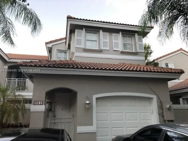 a front view of a house with garage