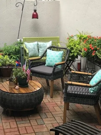 a view of an outdoor sitting area with brick walls