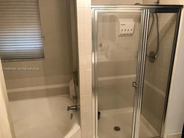 a bathroom with a glass shower door