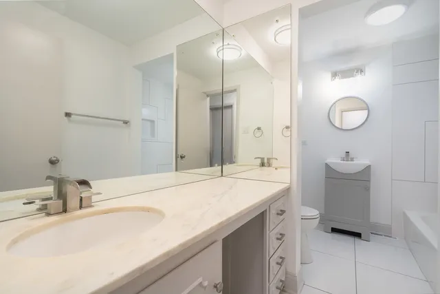 a spacious bathroom with a sink double vanity and a mirror