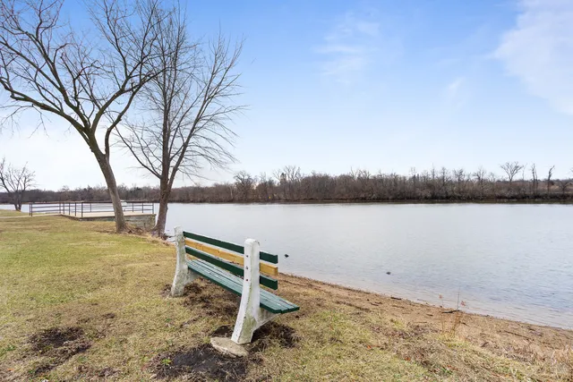 a view of lake with green space and fog
