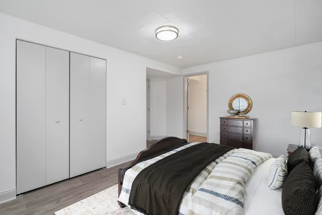 a bedroom with a bed and a lamp