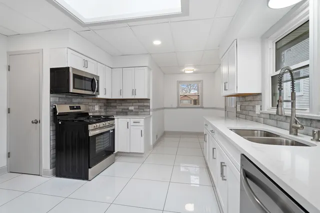 a kitchen with a sink stove and microwave