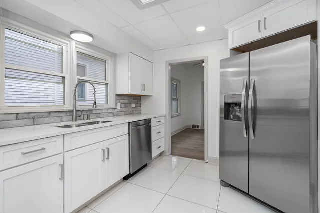 a kitchen with a refrigerator and a sink