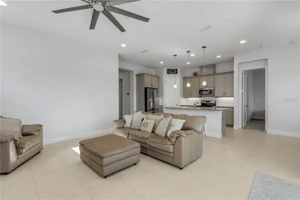 a living room with furniture and kitchen view