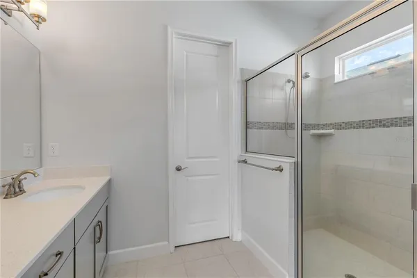 a bathroom with a shower and a sink