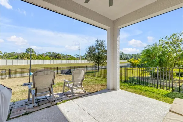 a view of a swimming pool with an outdoor seating and a garden
